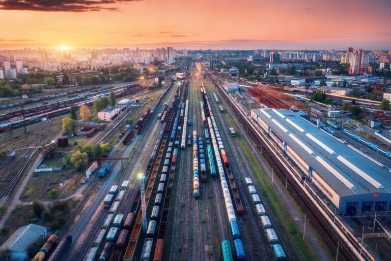 Aerial view of freight trains at sunset. Top view of railroad