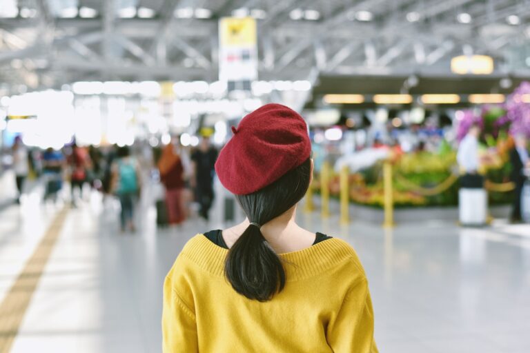 Asian woman standing in trade fair exhibition hall