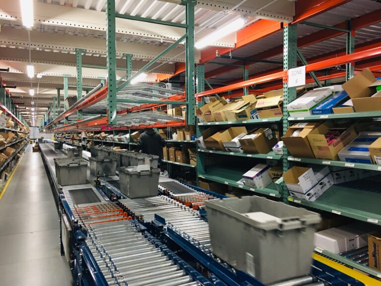 Goods travel by conveyor belt at a warehouse fulfillment center.